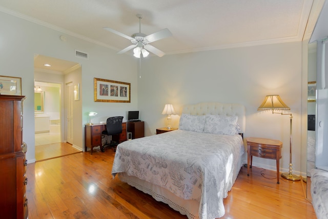 bedroom with hardwood / wood-style flooring, ceiling fan, crown molding, and ensuite bath