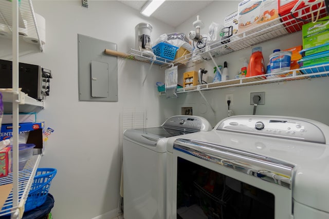 clothes washing area featuring washing machine and dryer and electric panel