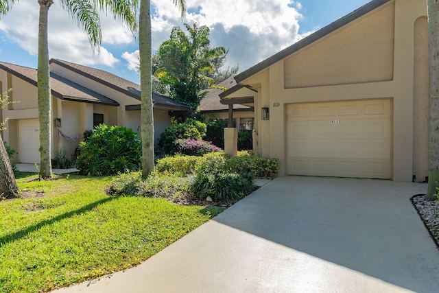 ranch-style home featuring a front lawn and a garage