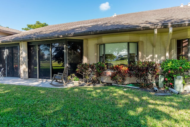 rear view of house with a yard