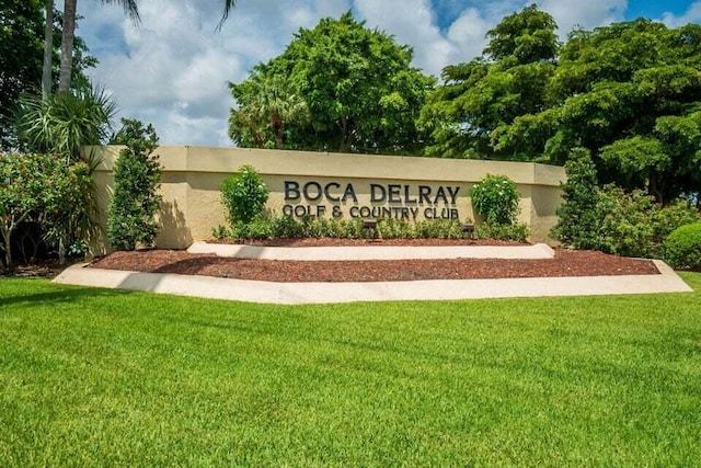 community / neighborhood sign with a lawn