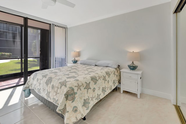 bedroom with access to outside, ceiling fan, a closet, and light tile patterned flooring