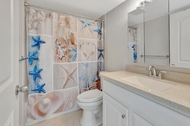 bathroom with tile patterned flooring, vanity, and toilet