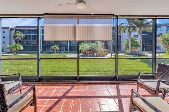 unfurnished sunroom with ceiling fan