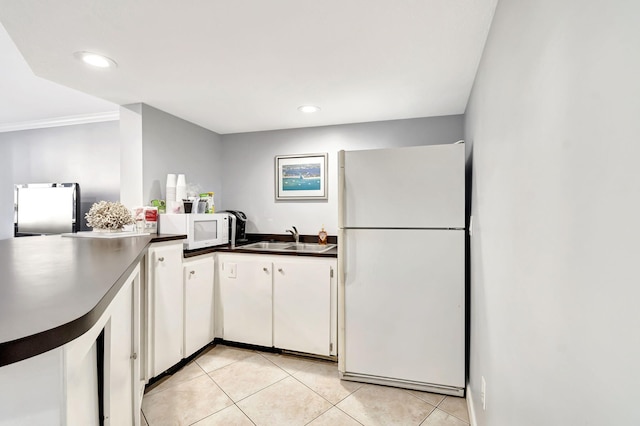 kitchen featuring white appliances, white cabinets, crown molding, sink, and light tile patterned floors