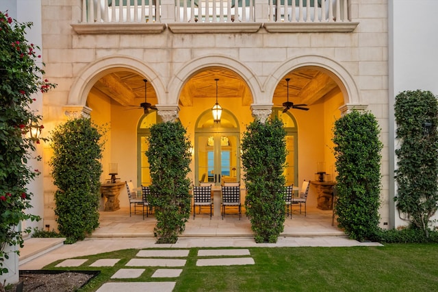 doorway to property with a balcony and ceiling fan