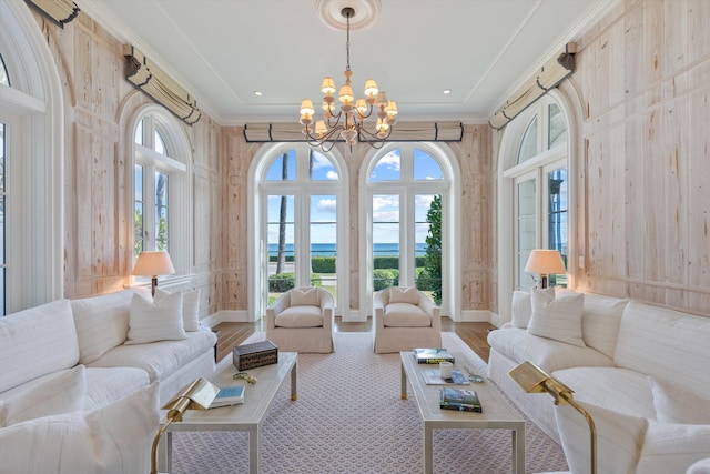 sunroom / solarium featuring an inviting chandelier and plenty of natural light