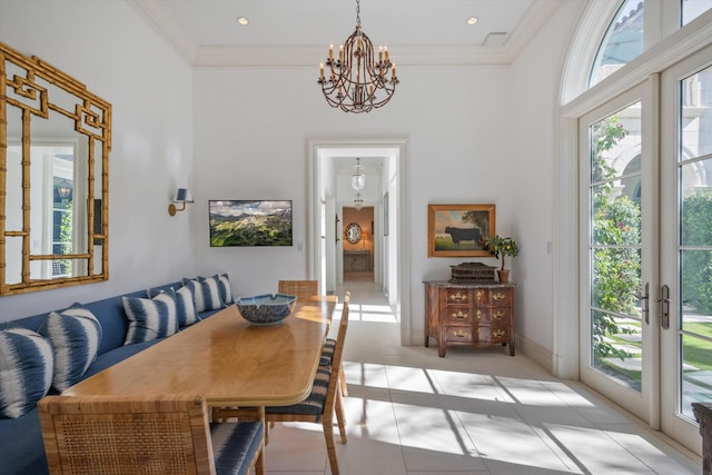 tiled dining area featuring an inviting chandelier, ornamental molding, and french doors