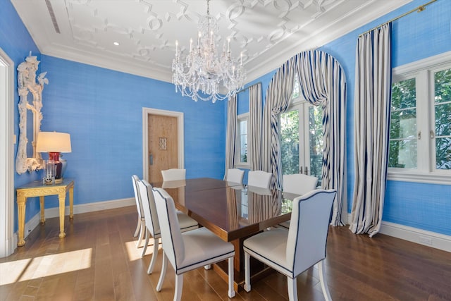 dining area with dark hardwood / wood-style flooring, an inviting chandelier, and ornamental molding