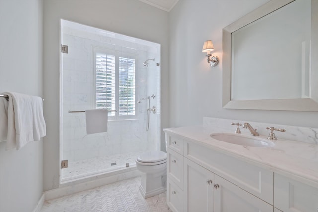 bathroom featuring ornamental molding, vanity, a shower with shower door, and toilet