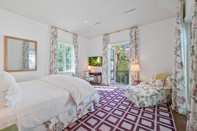 bedroom with access to exterior, crown molding, and hardwood / wood-style floors