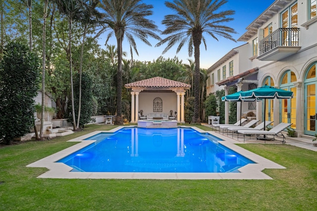 view of pool featuring a lawn and a patio