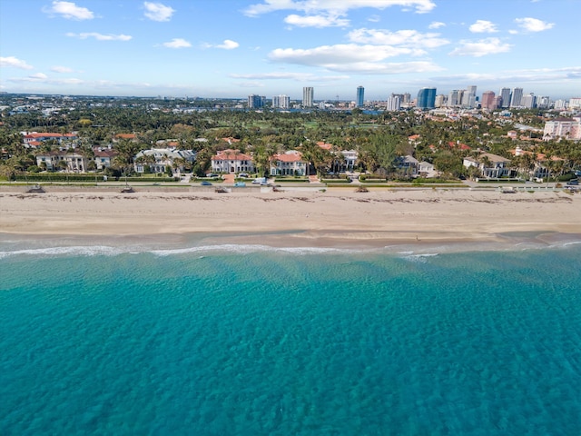 birds eye view of property with a beach view and a water view