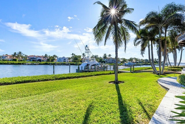 view of community with a water view and a lawn