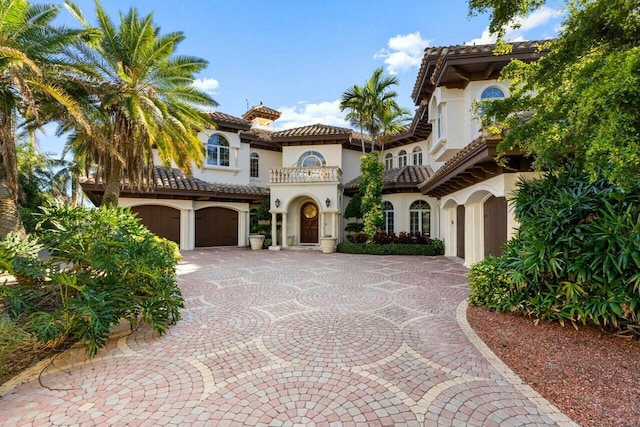 mediterranean / spanish house featuring a balcony and a garage