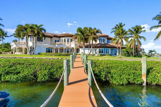 view of dock featuring a water view and a balcony