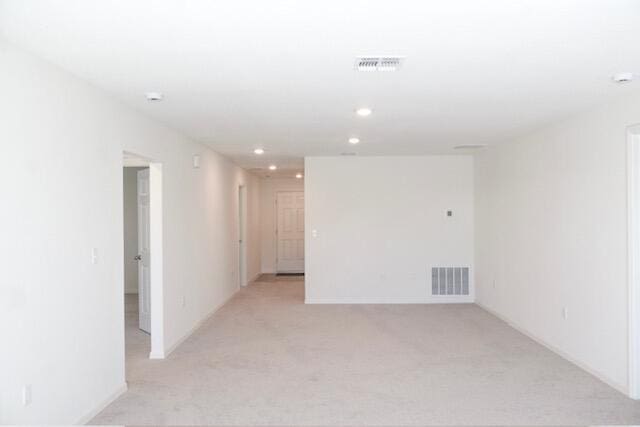 unfurnished room with light colored carpet