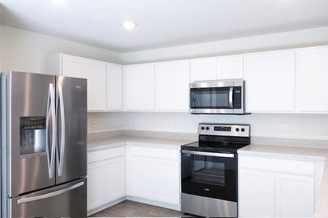 kitchen featuring white cabinets and appliances with stainless steel finishes