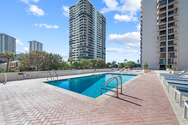 community pool featuring a view of city and a patio