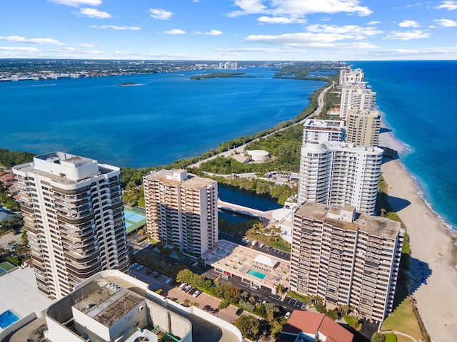 birds eye view of property with a water view and a view of city