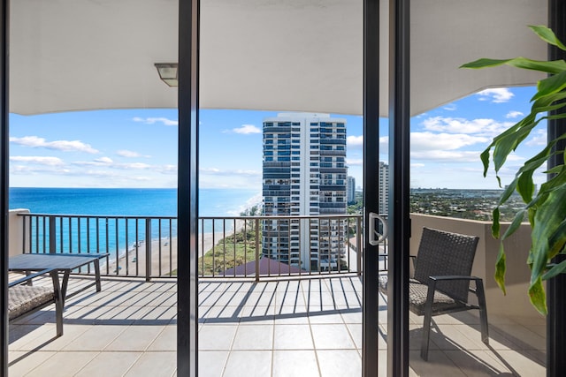 balcony with a water view and a beach view