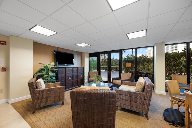 living room with a wall of windows and french doors