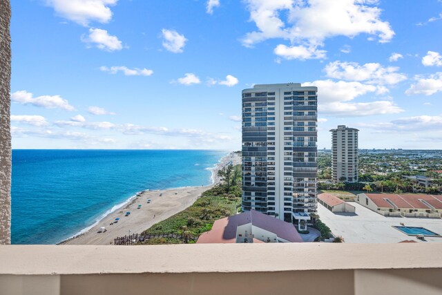 birds eye view of property with a water view and a view of the beach