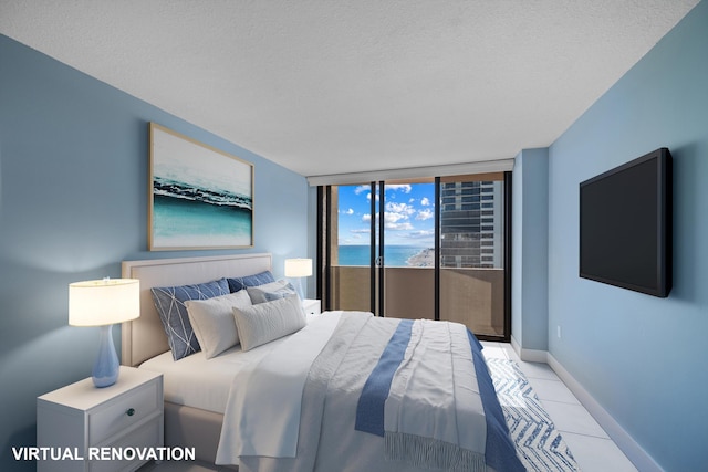 bedroom featuring a textured ceiling, access to outside, light tile patterned floors, and baseboards