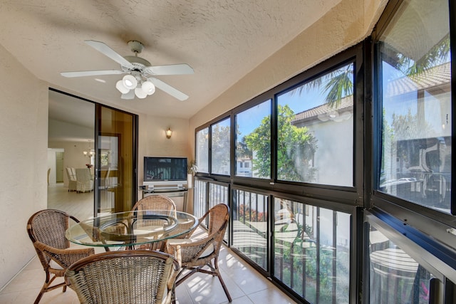 sunroom / solarium featuring ceiling fan