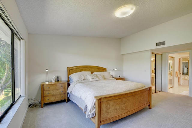 7230 Clunie Pl Unit 15403, Delray Beach, FL 33446 - bedroom with light carpet, a textured ceiling, and ensuite bath