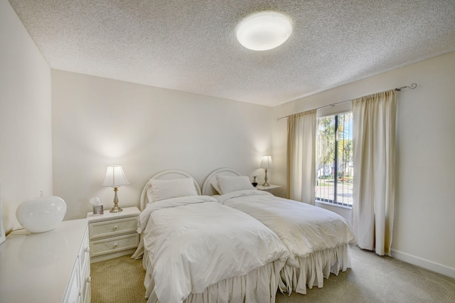 carpeted bedroom featuring a textured ceiling