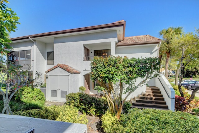 7230 Clunie Pl Unit 15403, Delray Beach, FL 33446 - view of front of property featuring stucco siding, a tiled roof, and stairway