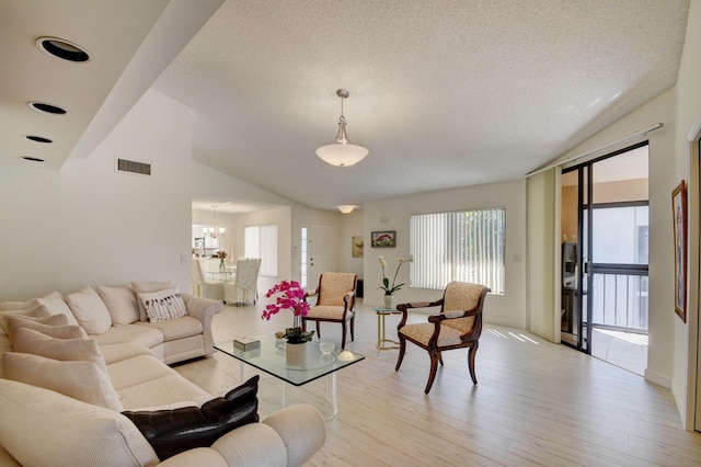 7230 Clunie Pl Unit 15403, Delray Beach, FL 33446 - living area featuring light wood finished floors, a chandelier, lofted ceiling, and a textured ceiling