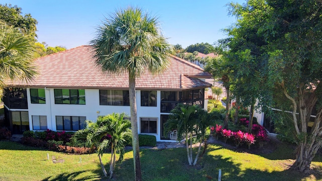 7230 Clunie Pl Unit 15403, Delray Beach, FL 33446 - back of property with a tiled roof, a lawn, and stucco siding