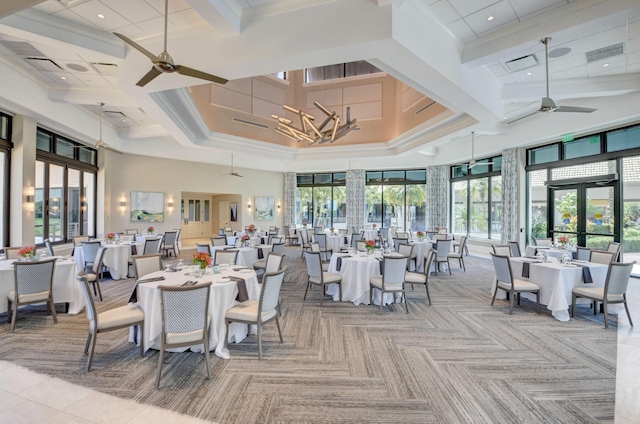 dining space with ceiling fan, a towering ceiling, french doors, and coffered ceiling