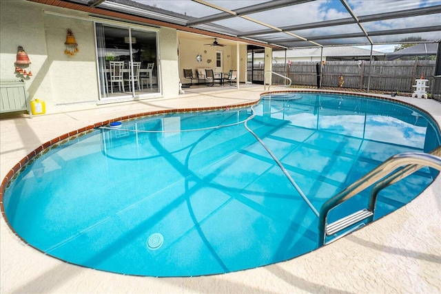 view of pool featuring glass enclosure and a patio area