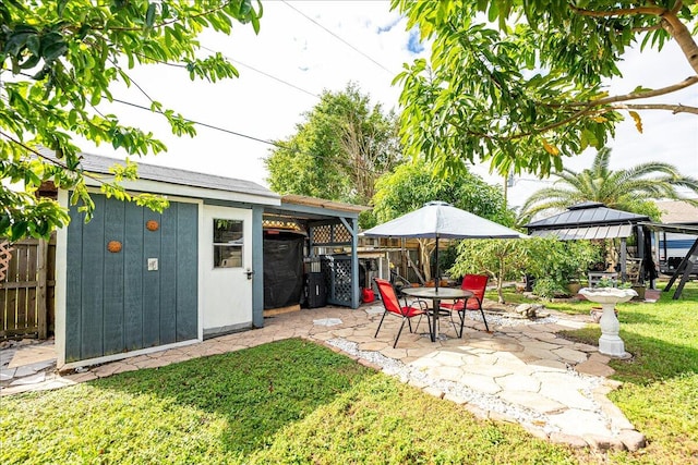 view of yard featuring a patio and an outdoor structure