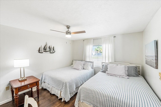 bedroom featuring dark hardwood / wood-style floors, ceiling fan, and a textured ceiling