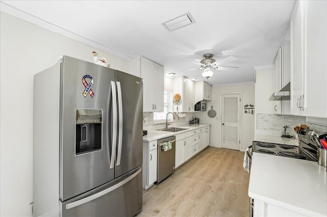 kitchen featuring white cabinets, stainless steel appliances, light hardwood / wood-style flooring, and sink