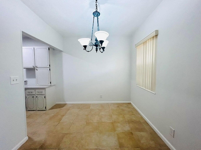 unfurnished dining area with light tile patterned floors and a notable chandelier