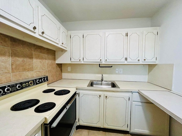 kitchen with decorative backsplash, white electric range, white cabinetry, and sink