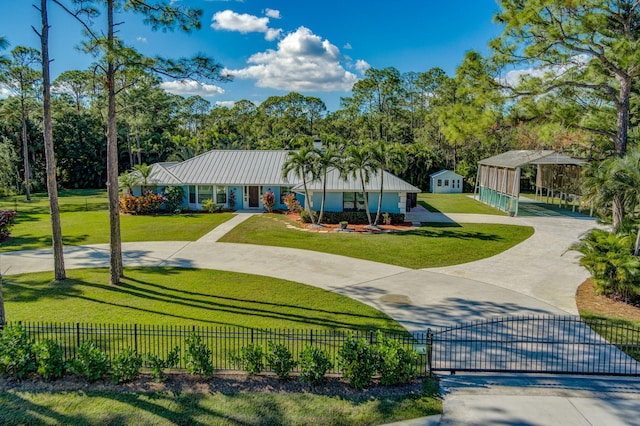 view of front of house with an outdoor structure and a front lawn