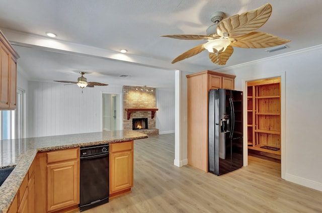 kitchen with light hardwood / wood-style flooring, ornamental molding, a fireplace, light brown cabinetry, and black fridge with ice dispenser