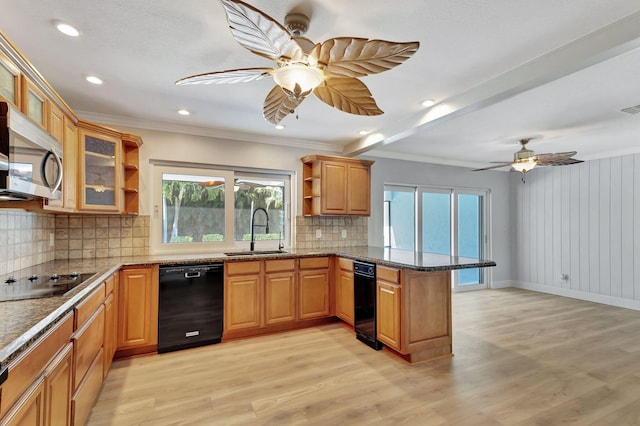 kitchen with black appliances, light wood-type flooring, kitchen peninsula, and sink