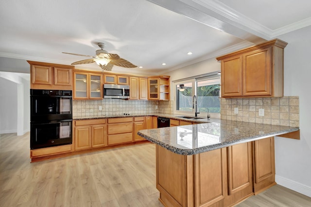 kitchen with light stone countertops, light hardwood / wood-style flooring, black appliances, and ornamental molding