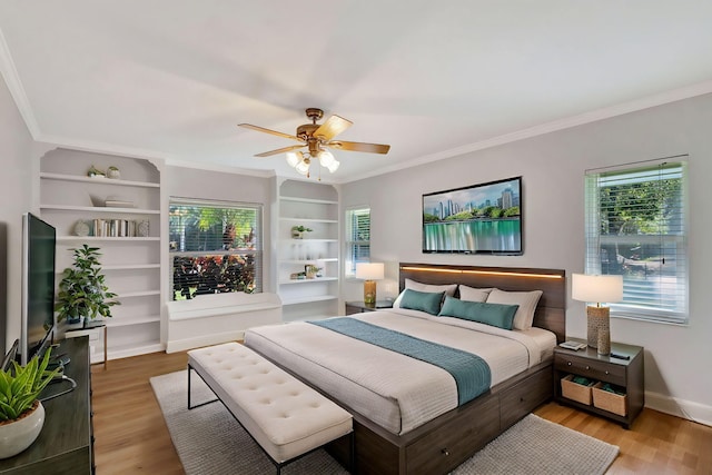 bedroom featuring hardwood / wood-style flooring, ceiling fan, and ornamental molding