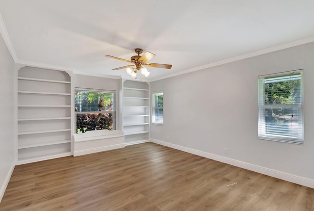 unfurnished living room with ceiling fan, built in features, wood-type flooring, and ornamental molding