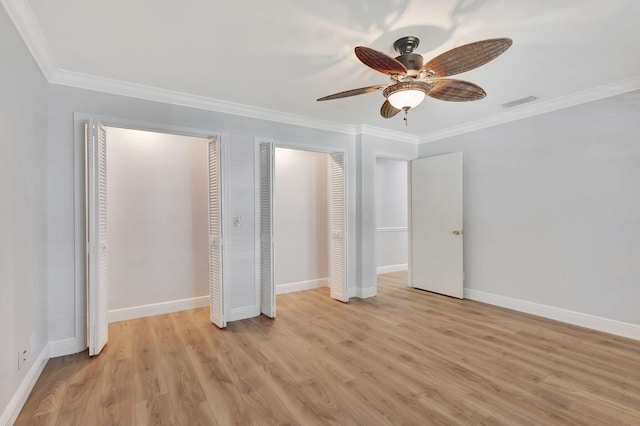 unfurnished bedroom with multiple closets, light wood-type flooring, ceiling fan, and crown molding