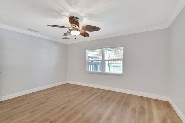 spare room with light wood-type flooring, ceiling fan, and ornamental molding