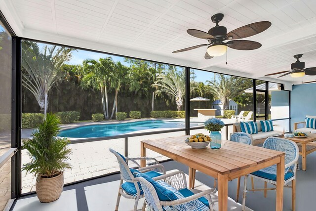 sunroom featuring ceiling fan